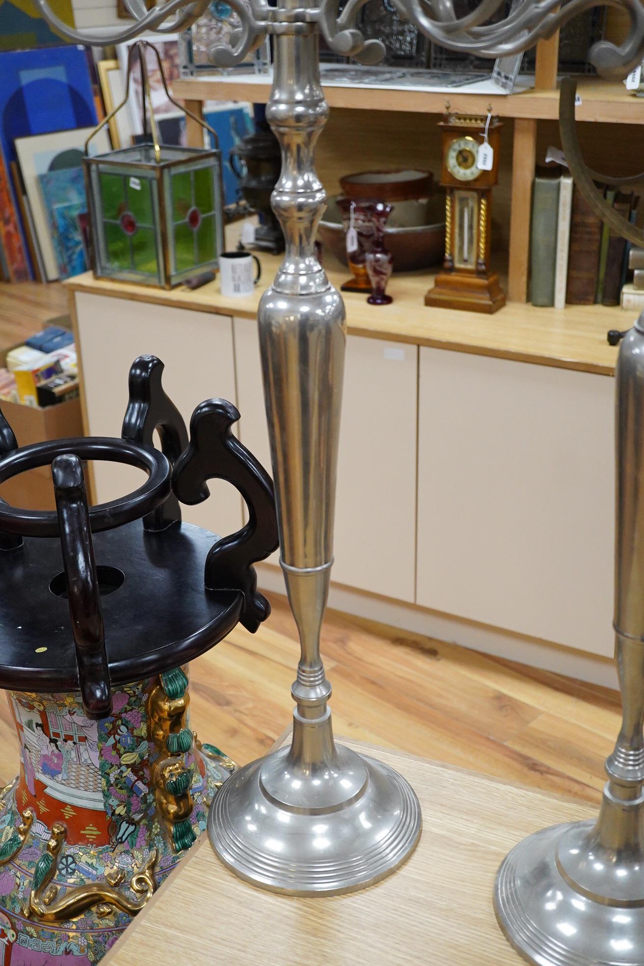A pair of tall pewter four branch, five light candelabra, 105cm high